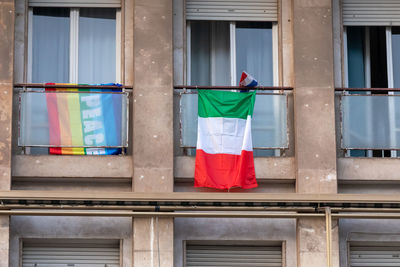 The italians locked up in the quarantined house display the rainbow flag on the windows