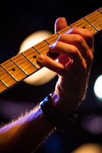 Cropped image of hand playing guitar