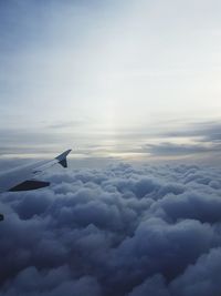 Airplane flying over cloudscape against sky