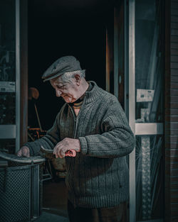 Man standing by window in winter