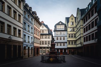 Street amidst buildings against sky in city