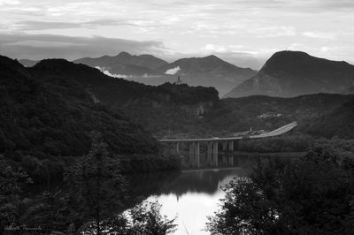 Bridge over river with mountains in background
