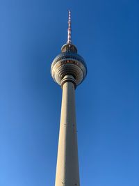 Low angle view of communications tower against sky