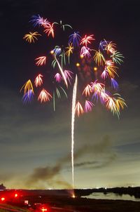 Low angle view of firework display at night