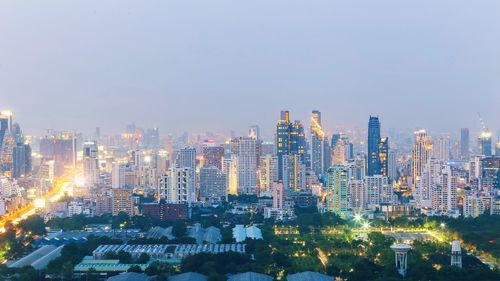 Aerial view of buildings in city against clear sky