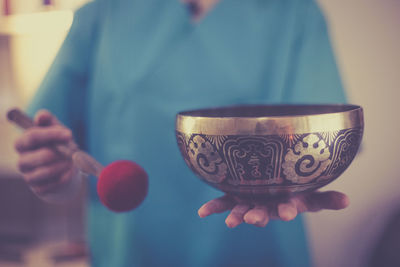 Close-up of hand holding tea cup