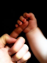 Close-up of hands holding baby hand