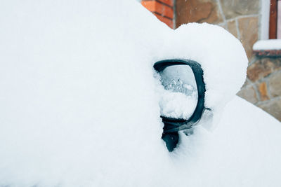 Close-up of snow covered car