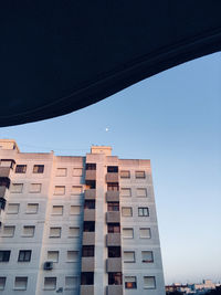 Low angle view of buildings against clear blue sky