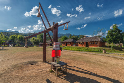 Play equipment at playground against sky