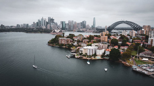 High angle view of buildings by river against sky