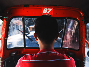 Reflection of man in bus