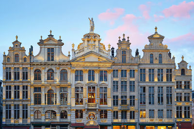 Illuminated buildings against sky during sunset