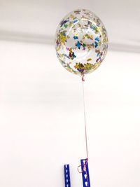 Low angle view of balloons against white background