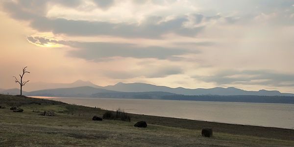 Scenic view of lake and mountains against sky