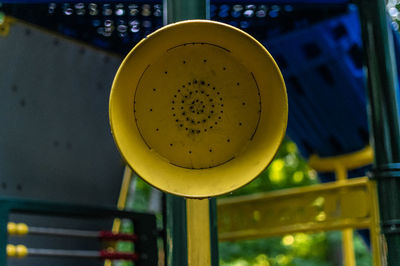 Close-up of yellow machine in container