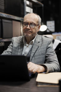 Young man using laptop at desk in office