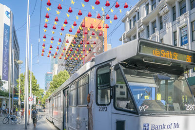 View of train in city against sky