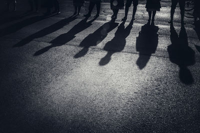 Low section of people standing on sidewalk