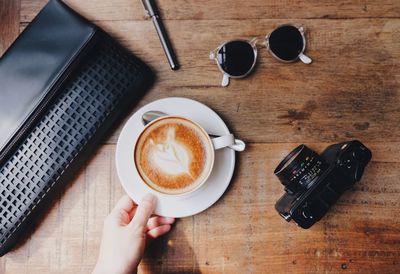 High angle view of woman and coffee cup on table