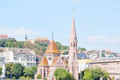 Buildings in city against sky