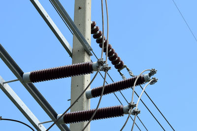 Low angle view of cables against clear blue sky