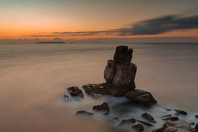 Scenic view of sea against sky at sunset