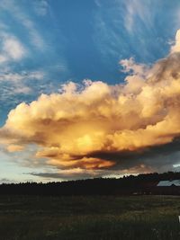 Scenic view of field against sky at sunset