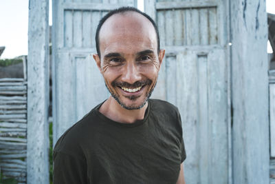 Portrait of smiling man standing outdoors