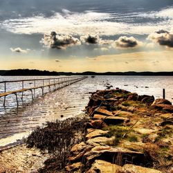 Pier on sea at sunset