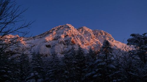 Scenic view of mountains against clear blue sky