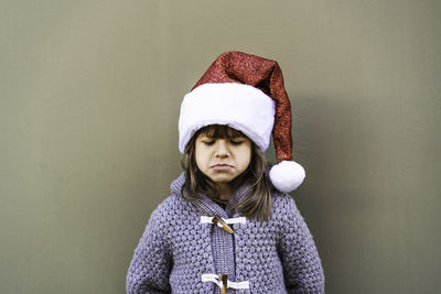 Portrait of woman wearing hat against wall