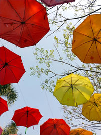 Low angle view of umbrellas against sky