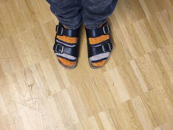 Low section of woman standing on tiled floor