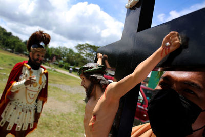 Group of people standing on land against the sky