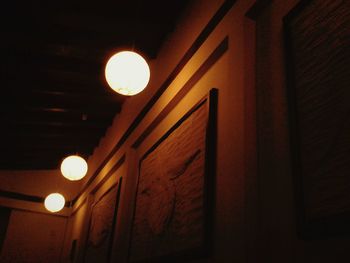 Low angle view of illuminated building against sky at night