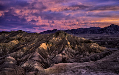 Scenic view of mountains against cloudy sky