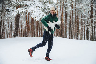 Full length of man standing on snow covered land