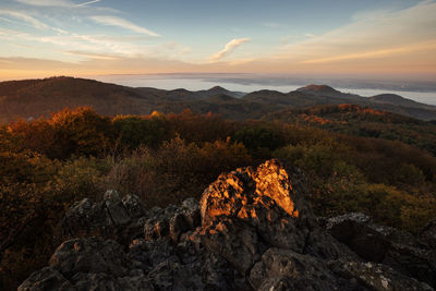 Scenic view of rock against sky during sunset