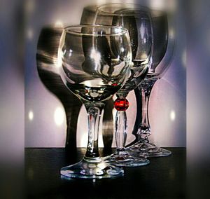 Close-up of wine glasses on table