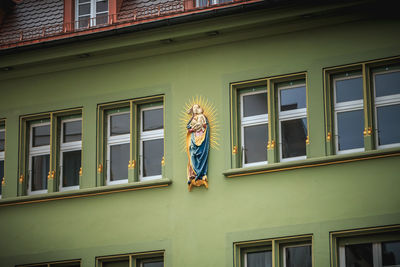 Low angle view of person standing against building