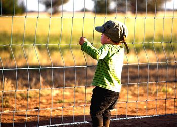 Full length of boy standing on field