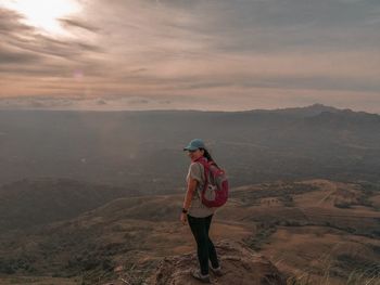 Full length of man standing on mountain against sky