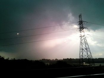 Low angle view of electricity pylon against sky