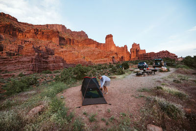 Woman sets up camp under the fisher towers near moab utah