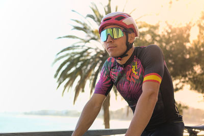 Palm trees on the beach and a cyclist ready for a training session.