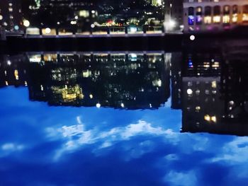 Reflection of illuminated buildings in water at night