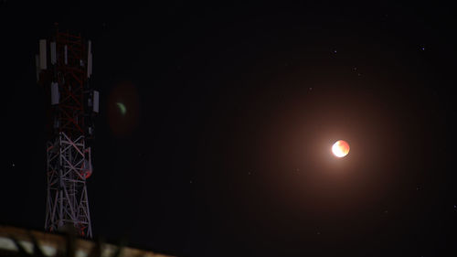 Low angle view of illuminated moon against sky at night