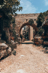 Old building by trees against sky