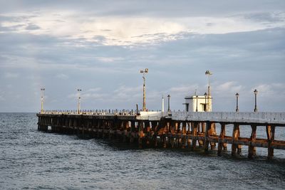 Pier over sea against sky